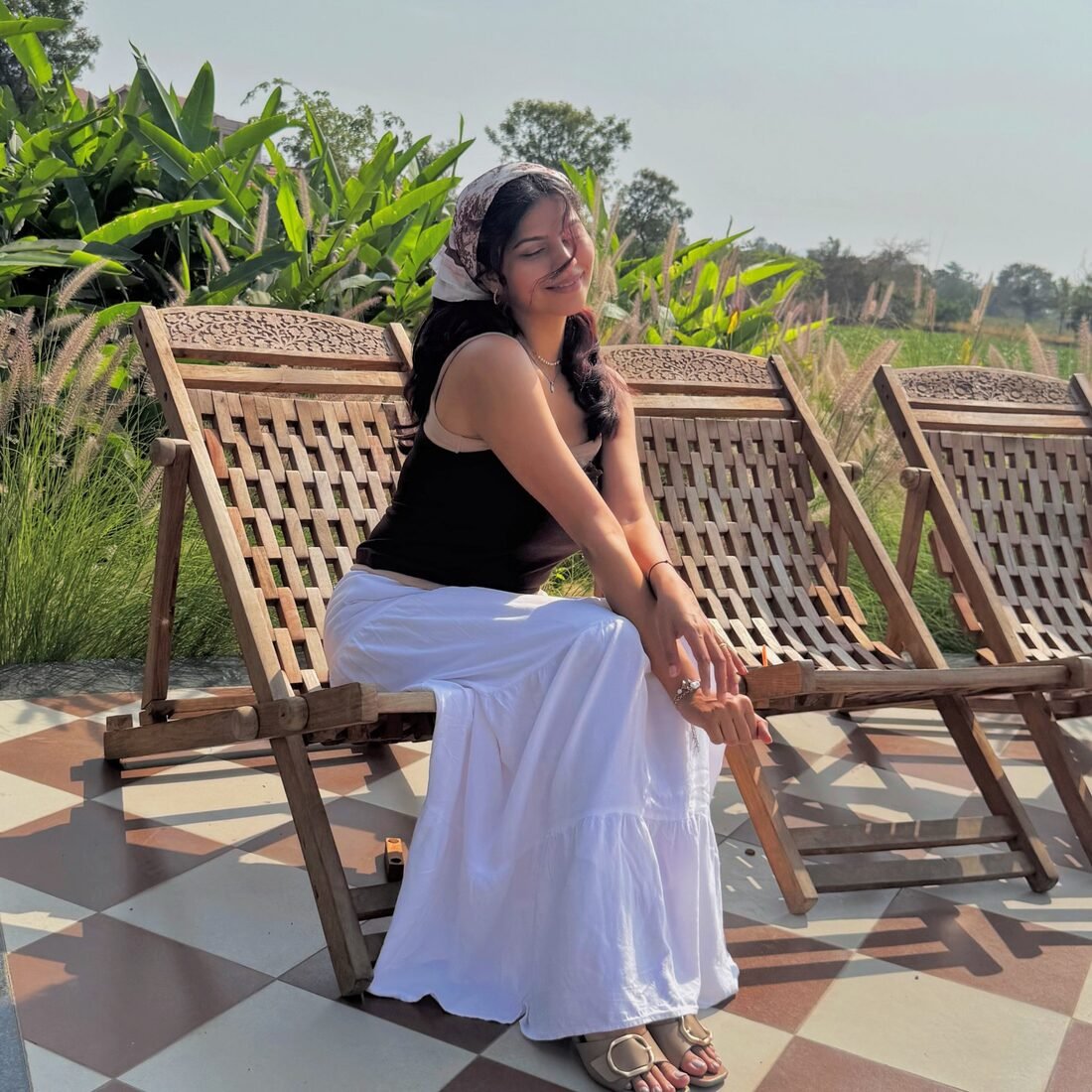 Shreya Jadhav on a deck chair at a resort